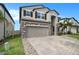 Two-story house with stone accents and a paver driveway at 3071 Marine Grass Dr, Wimauma, FL 33598