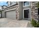 Dark brown front door with stone accents at 3071 Marine Grass Dr, Wimauma, FL 33598