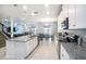 Open concept kitchen island with granite countertops, stainless steel appliances, and views to living and dining areas at 3071 Marine Grass Dr, Wimauma, FL 33598