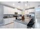 Modern kitchen with white cabinets and granite countertops at 3071 Marine Grass Dr, Wimauma, FL 33598