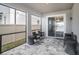 Relaxing screened porch with seating area and sliding glass doors at 3071 Marine Grass Dr, Wimauma, FL 33598