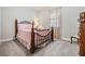 Charming bedroom with pink bedding and wood frame bed at 31703 Cabana Rye Ave, San Antonio, FL 33576