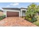 House exterior with brick driveway and palm trees at 31703 Cabana Rye Ave, San Antonio, FL 33576