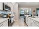 Modern kitchen with white cabinets and stainless steel appliances at 31703 Cabana Rye Ave, San Antonio, FL 33576