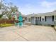 Large backyard patio with a teal patio set and detached garage at 320 N Madison Ave, Clearwater, FL 33755