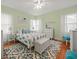 Bedroom with light green walls, pineapple bedding, and hardwood floors at 320 N Madison Ave, Clearwater, FL 33755