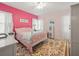 Bedroom with pink walls, floral bedding, and a ceiling fan at 320 N Madison Ave, Clearwater, FL 33755