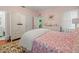 Bedroom with pink walls, floral bedding and white wardrobe at 320 N Madison Ave, Clearwater, FL 33755