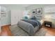 Bedroom with light walls, gray bedding, and hardwood floors at 320 N Madison Ave, Clearwater, FL 33755