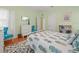 Bright bedroom with a pineapple patterned comforter and teal accent chairs at 320 N Madison Ave, Clearwater, FL 33755