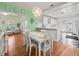 Bright dining area with white table and chairs, and light green walls at 320 N Madison Ave, Clearwater, FL 33755