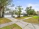 Home with attached garage and a spacious front yard at 320 N Madison Ave, Clearwater, FL 33755