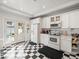 White kitchen features a checkerboard floor and French doors to backyard at 320 N Madison Ave, Clearwater, FL 33755