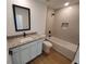 Bathroom with granite countertop vanity, bathtub and tile flooring at 3355 Moncrief Ave, North Port, FL 34286