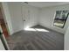 Bright bedroom with grey carpet and large window at 3355 Moncrief Ave, North Port, FL 34286