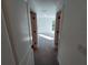 Well-lit hallway with carpeted floor leading to bedrooms at 3355 Moncrief Ave, North Port, FL 34286