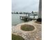 Wooden dock extending over calm water with views of boats and homes at 341 E Madeira Ave, Madeira Beach, FL 33708