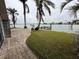 Landscaped backyard with private dock and water access at 341 E Madeira Ave, Madeira Beach, FL 33708