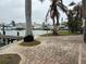 Brick paved patio area with palm trees and waterfront views at 341 E Madeira Ave, Madeira Beach, FL 33708