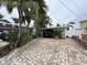 House with covered carport and brick paver driveway, offering ample parking space at 341 E Madeira Ave, Madeira Beach, FL 33708