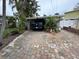 House with covered carport and brick paver driveway, offering ample parking space at 341 E Madeira Ave, Madeira Beach, FL 33708