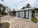 Home exterior with paver driveway and attached garage at 341 E Madeira Ave, Madeira Beach, FL 33708