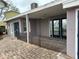 Home's exterior features a covered patio area and a brick-paved walkway at 341 E Madeira Ave, Madeira Beach, FL 33708