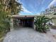 House exterior featuring a paved driveway and landscaping at 341 E Madeira Ave, Madeira Beach, FL 33708