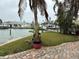 Landscaped waterfront property with palm trees and brick-paved pathways at 341 E Madeira Ave, Madeira Beach, FL 33708