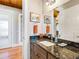 Bathroom with granite countertop, dark wood cabinets and sink at 36511 Frazee Hill Rd, Dade City, FL 33523