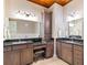 Bathroom with double vanity, granite countertop and large mirror at 36511 Frazee Hill Rd, Dade City, FL 33523