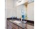 Bathroom with granite countertop and dark wood cabinets at 36511 Frazee Hill Rd, Dade City, FL 33523