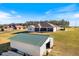 House exterior with green metal garage and large backyard at 36511 Frazee Hill Rd, Dade City, FL 33523