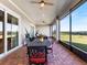 Screened porch with dining area and view at 36511 Frazee Hill Rd, Dade City, FL 33523