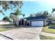 House exterior boasts a stone and blue facade, a large garage, and a well-manicured lawn at 4101 Concord Way, Plant City, FL 33566