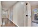 Light and bright hallway with wood-look flooring and access to other rooms at 4101 Concord Way, Plant City, FL 33566