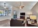 Bright living room with vaulted ceiling, sliding doors to pool, and dark leather furniture at 4101 Concord Way, Plant City, FL 33566