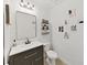 Stylish bathroom with dark vanity and decorative wall art at 4179 Bramblewood Loop, Spring Hill, FL 34609