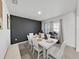 Dining room with a dark accent wall and large window at 4179 Bramblewood Loop, Spring Hill, FL 34609