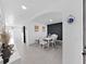 Modern dining room featuring a white table and chairs at 4179 Bramblewood Loop, Spring Hill, FL 34609