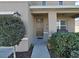 Inviting front porch with a rocking chair and landscaping at 4179 Bramblewood Loop, Spring Hill, FL 34609