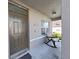 Front porch featuring a brown door and a rocking chair at 4179 Bramblewood Loop, Spring Hill, FL 34609