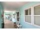 Shared hallway with light teal walls and window shutters at 423 S Paula Dr # 203, Dunedin, FL 34698