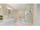 Spa-like bathroom with a soaking tub and glass shower at 443 Pinellas Bayway S # 104, St Petersburg, FL 33715