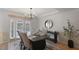 Elegant dining room featuring a dark wood table and French doors at 443 Pinellas Bayway S # 104, St Petersburg, FL 33715