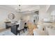 Bright dining room with a dark wood table and modern chandelier at 443 Pinellas Bayway S # 104, St Petersburg, FL 33715