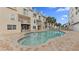 Community pool with brick patio and lounge chairs at 443 Pinellas Bayway S # 104, St Petersburg, FL 33715