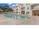 Community pool with brick patio and lounge chairs at 443 Pinellas Bayway S # 104, St Petersburg, FL 33715