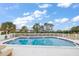 Inviting community pool area with surrounding trees and seating at 4550 Overlook Ne Dr # 257, St Petersburg, FL 33703