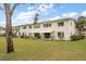 Back exterior view of condo building, showing lawn and landscaping at 4550 Overlook Ne Dr # 257, St Petersburg, FL 33703